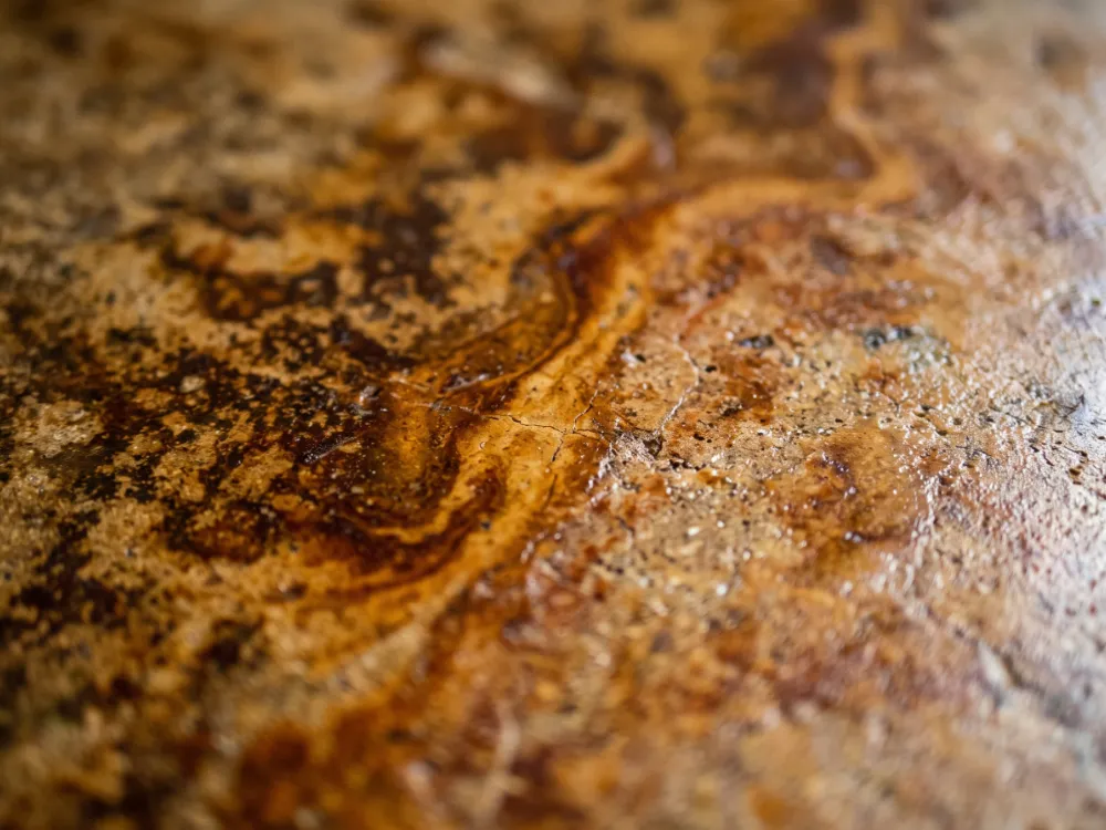 Variegated ochre and amber acid stain marbling on sealed concrete