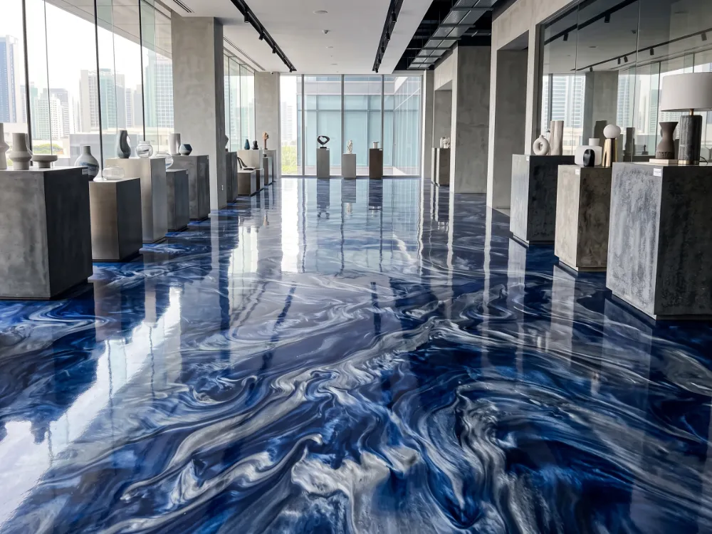 Marbleized blue and silver metallic epoxy floor in a modern showroom