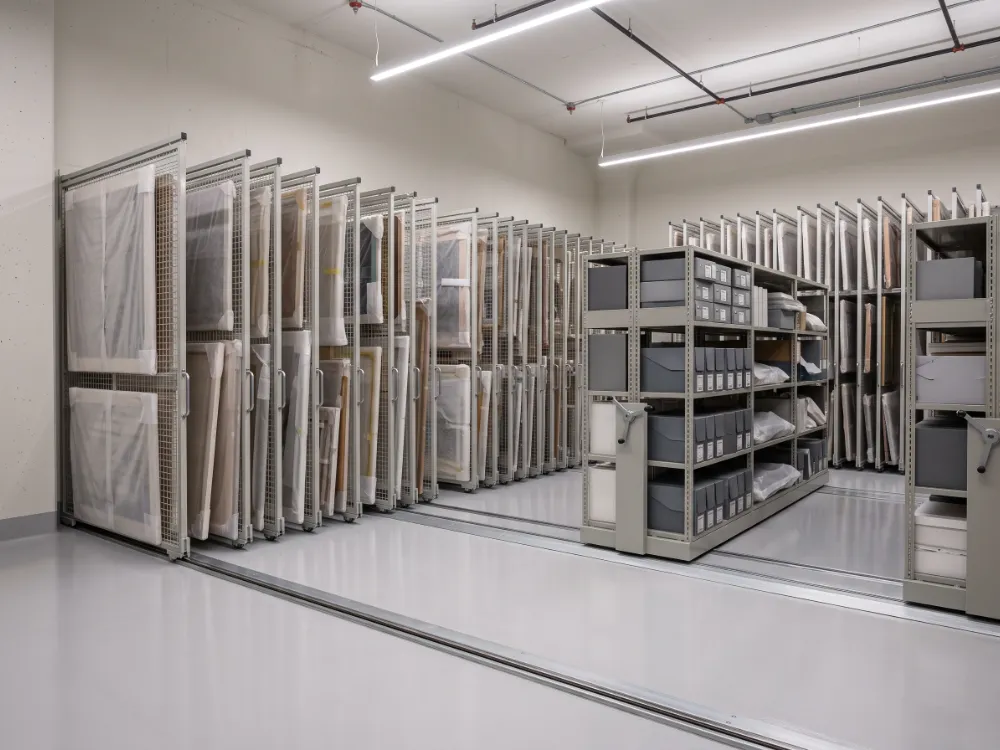 Collections storage with rolling art racks on a sealed coved floor
