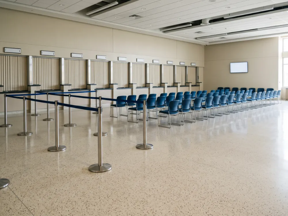 Consular service hall with a cream terrazzo-look epoxy floor and queue barriers