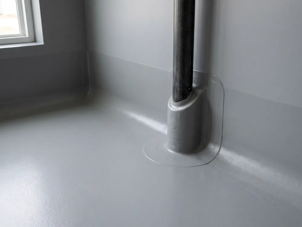 Epoxy membrane rising as a cove and wrapping a pipe penetration
