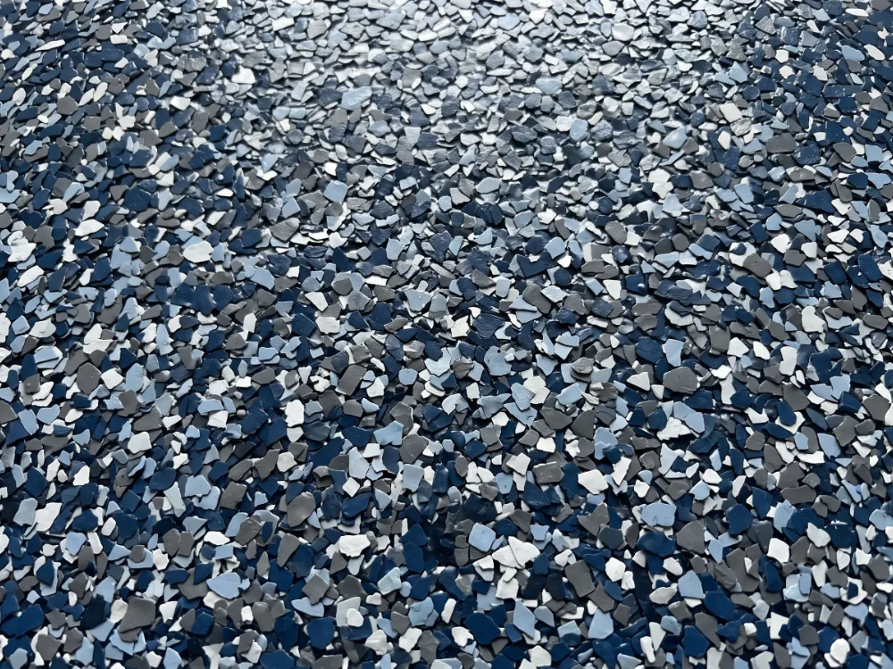 Dense blue gray and white flake blend fully covering a floor under satin clear coat