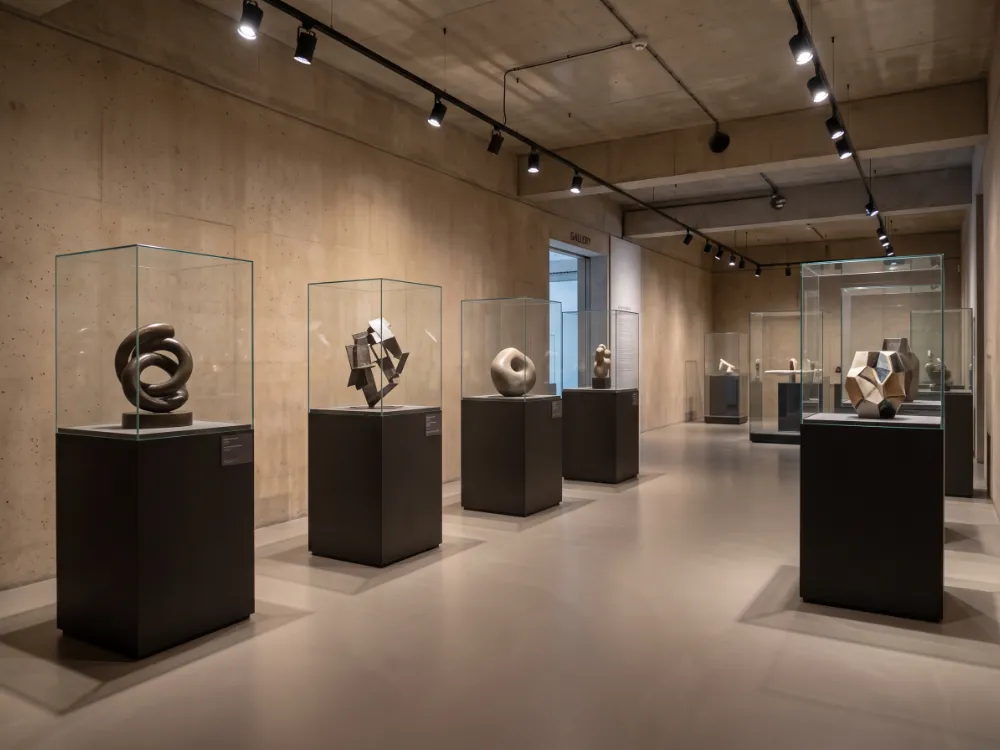 Museum exhibit hall with a matte greige epoxy floor and pedestals