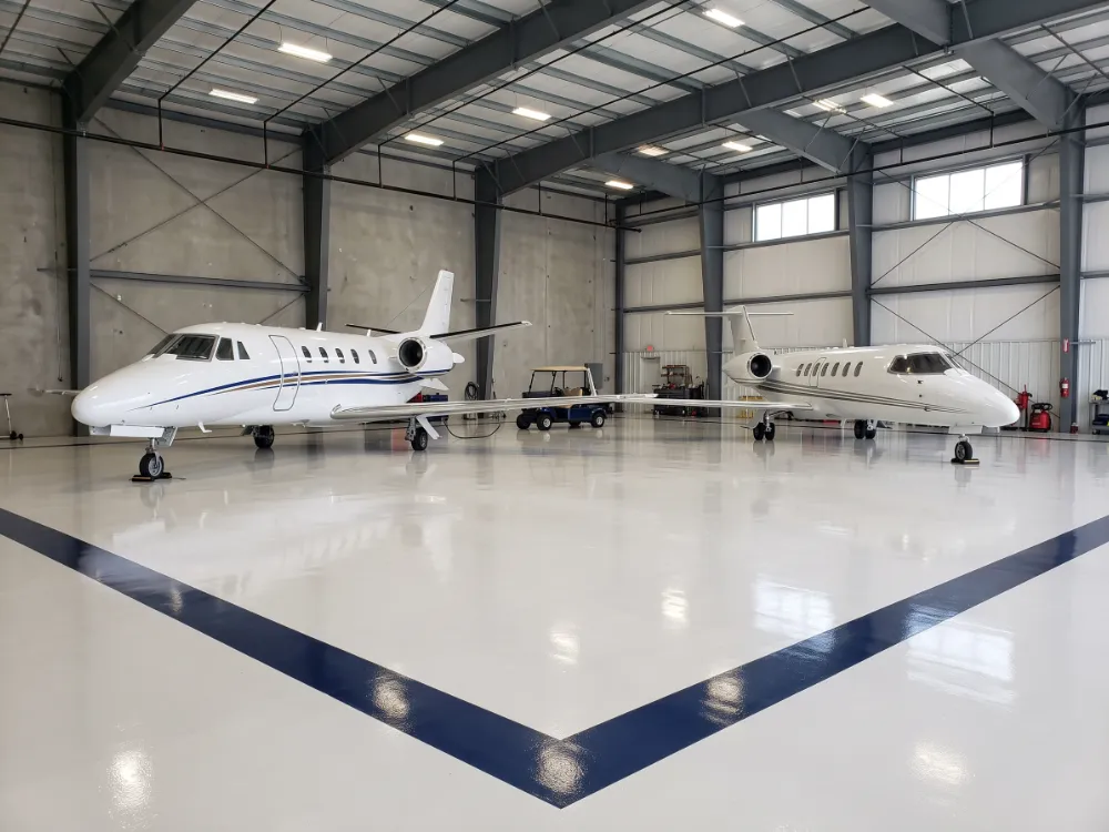 FBO hangar with a blue border stripe coated into a glossy epoxy floor