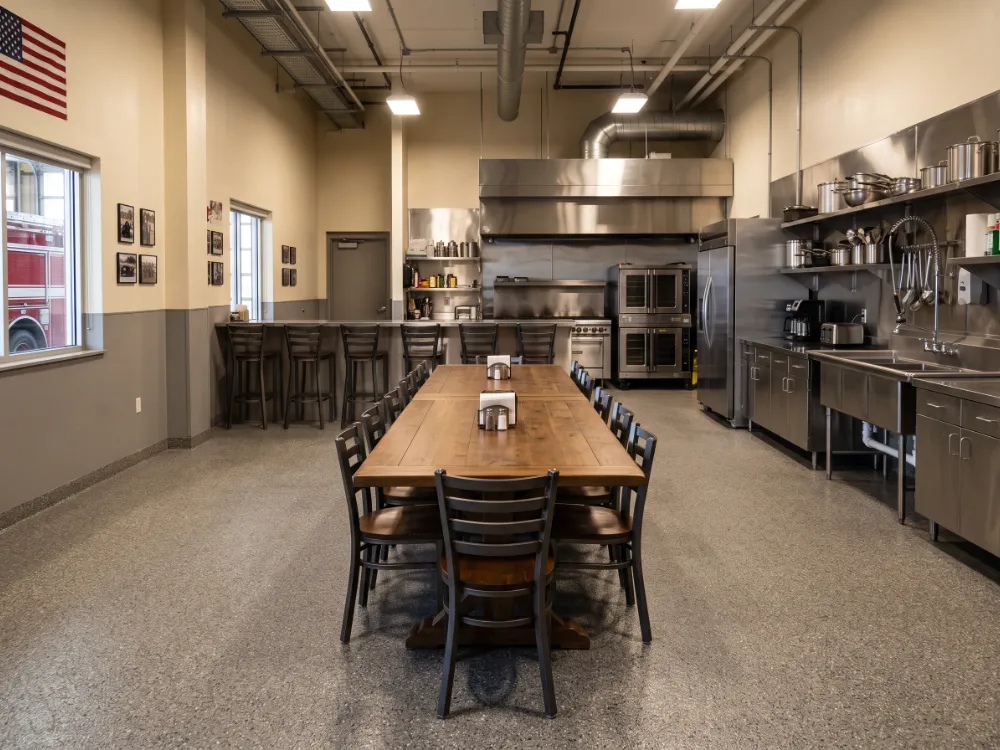 Fire station kitchen and dining area with a warm gray flake epoxy floor