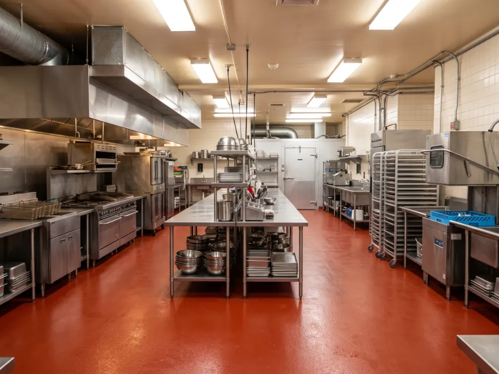 Hotel banquet kitchen with a red urethane cement floor and cove base
