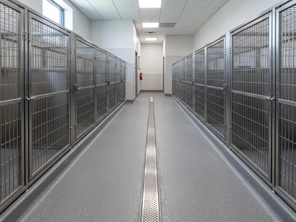 Kennel room with a textured epoxy floor sloping to a trench drain