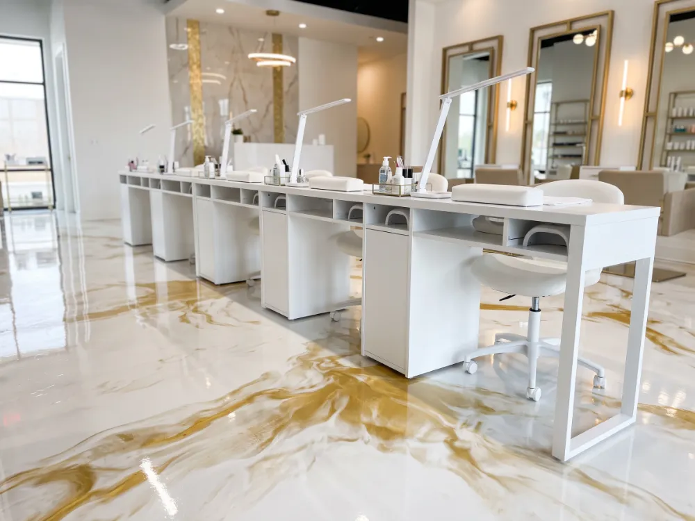 Manicure stations on a glossy white and gold metallic epoxy floor