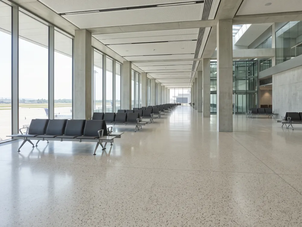 Passenger waiting hall with a light terrazzo-look epoxy floor