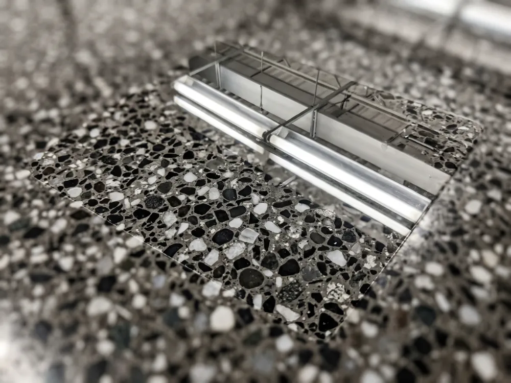 Highly polished concrete showing salt-and-pepper aggregate under mirror sheen