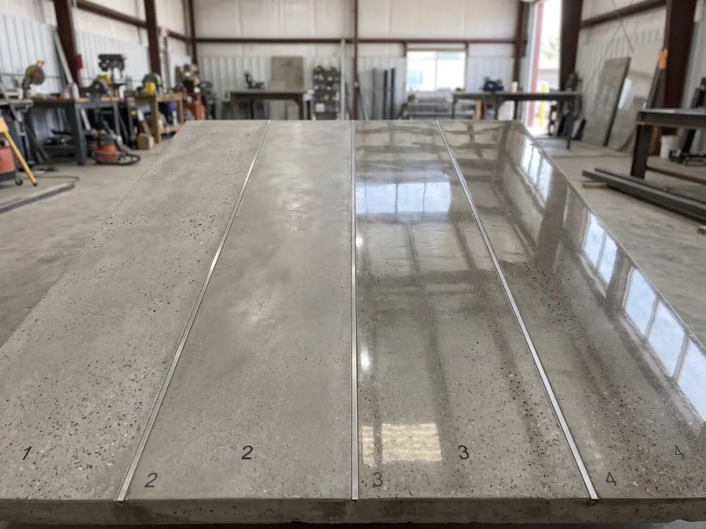 Four strips of concrete finished at increasing sheen levels from matte to mirror gloss