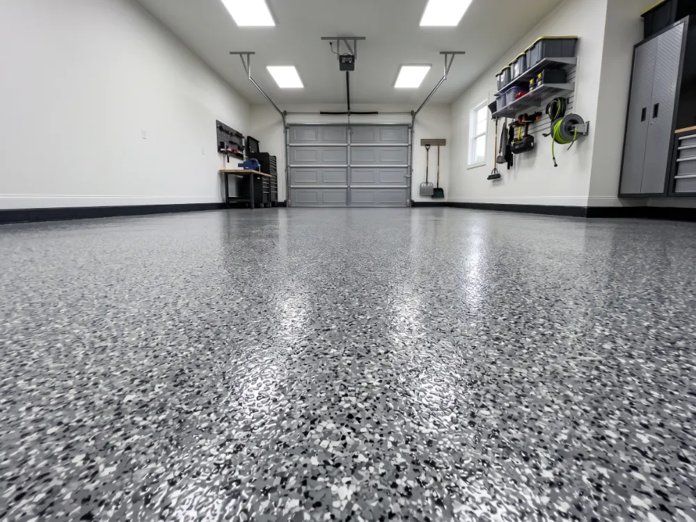 Resurfaced garage floor finished with a fresh gray flake broadcast system