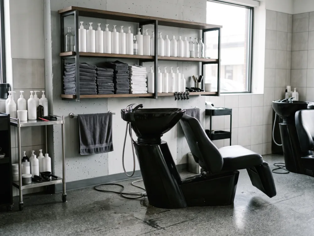Salon wash and utility area with a textured gray epoxy floor