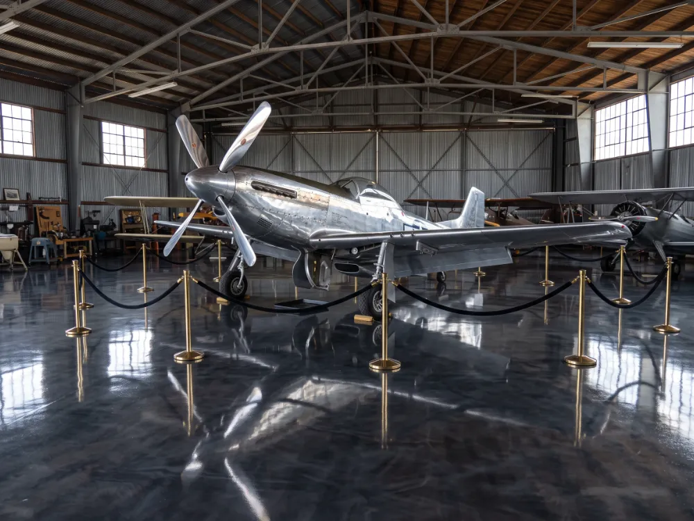 Vintage aircraft on a charcoal metallic epoxy display hangar floor