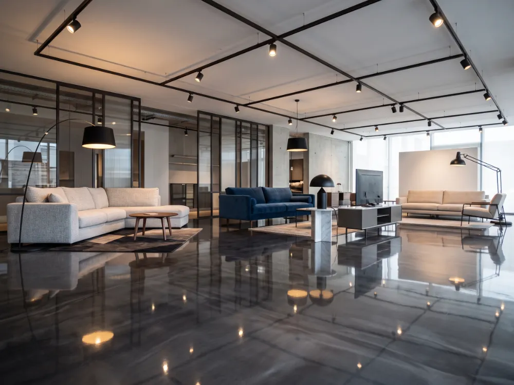 High-gloss charcoal metallic epoxy floor reflecting a furniture showroom