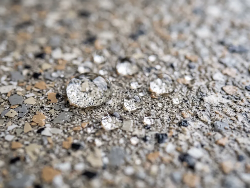 Water droplets beading on a textured slip-resistant flake coated deck surface