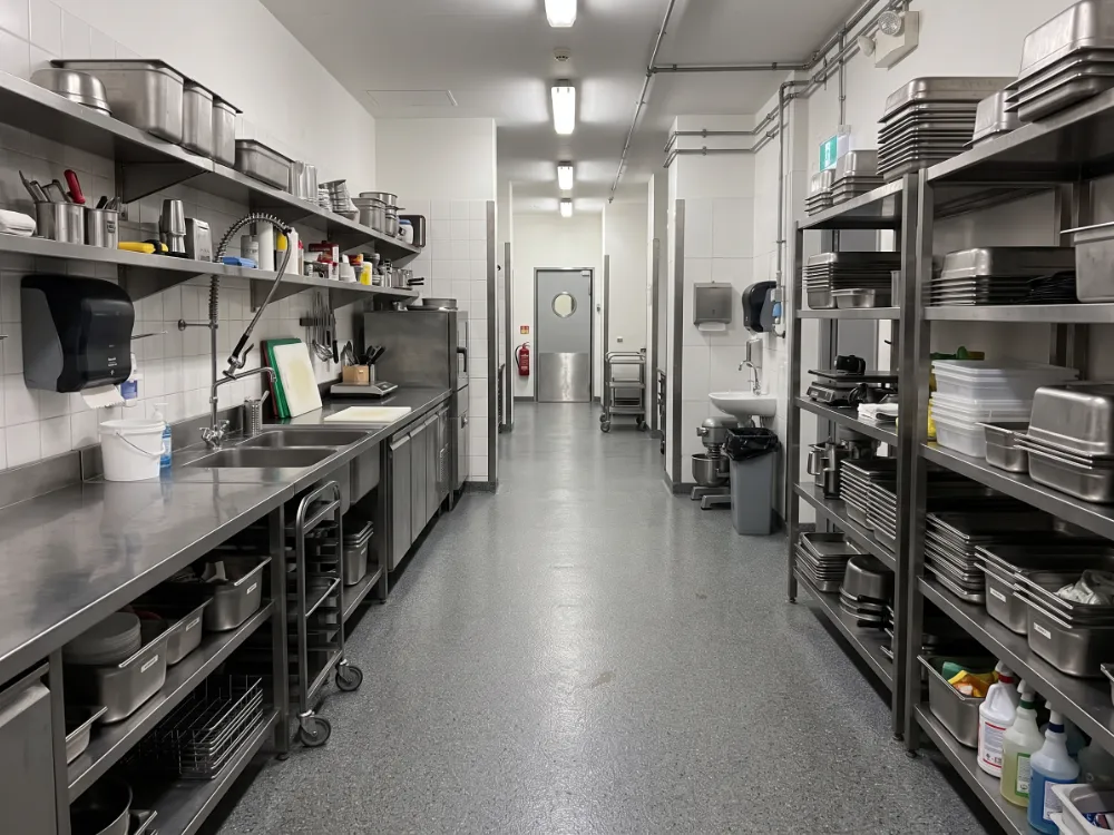 Staff kitchen and service corridor with a gray flake epoxy floor