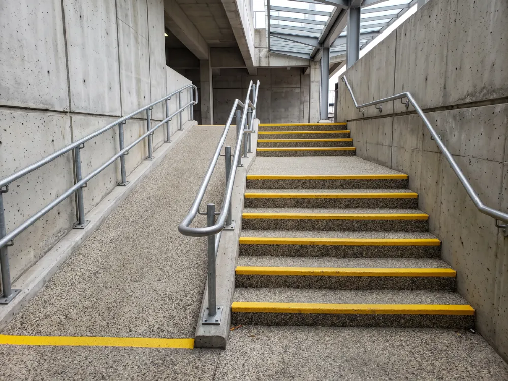 Station stairs with quartz epoxy treads and coated yellow nosing