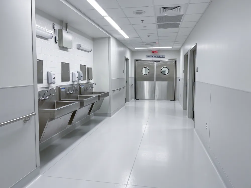 Surgical suite corridor with a seamless epoxy floor and scrub sinks