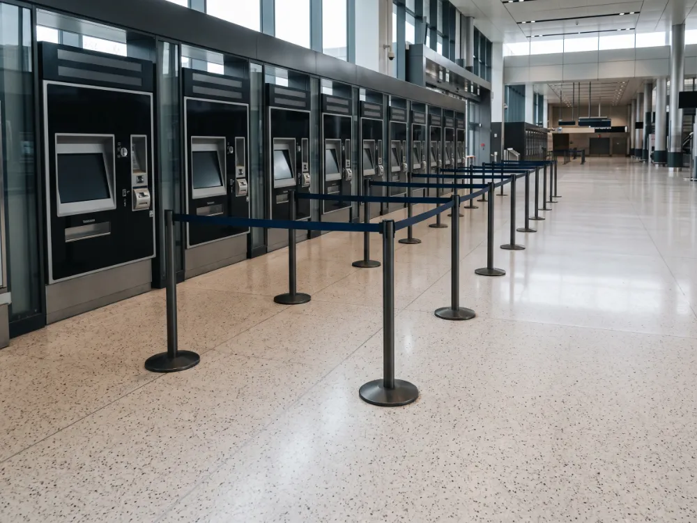 Ticket hall with a light terrazzo-look epoxy floor and machines