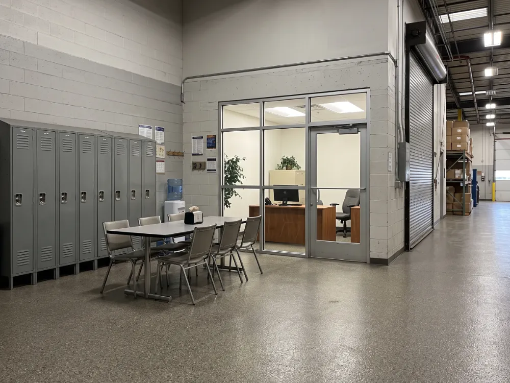 Warehouse break area and office entrance with a warm gray flake epoxy floor